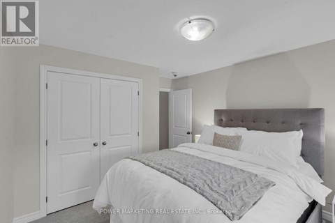 A bedroom with a large bed and a headboard.