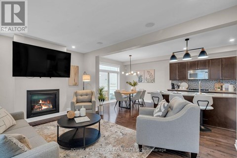 A modern living room with a fireplace and a television mounted on the wall.