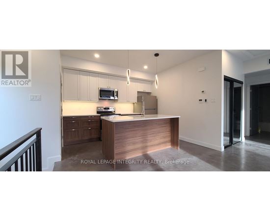 A modern kitchen with a wooden island and stainless steel appliances.