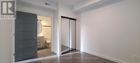 A bedroom with a toilet and a wardrobe.
