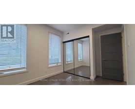 A room with a sliding door and a window with blinds.