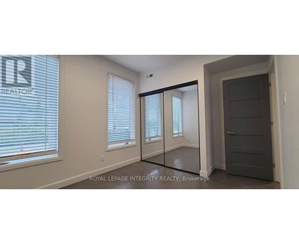 A room with a sliding door and a window with blinds.