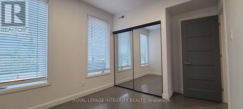 A room with a sliding door and a window with blinds.