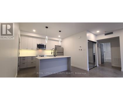 A kitchen with a sink and a microwave.