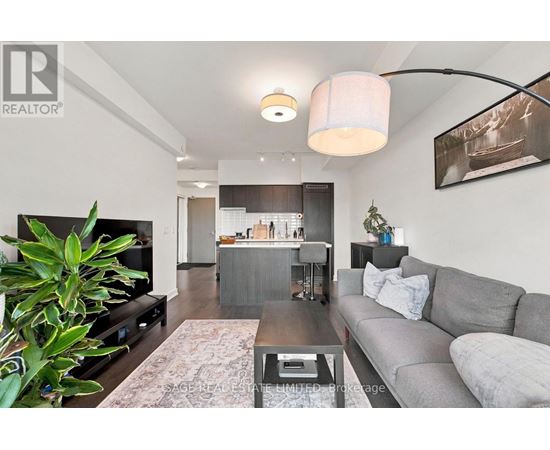 A living room with a grey couch and a coffee table.