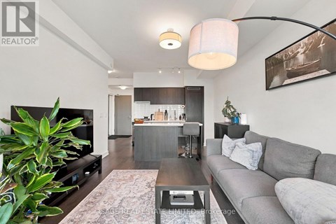 A living room with a grey couch and a coffee table.