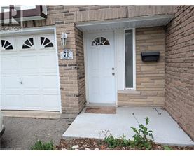 A white door with a window above it and a sign that says 70.