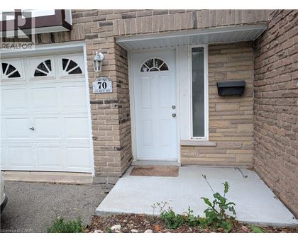 A white door with a window above it and a sign that says 70.