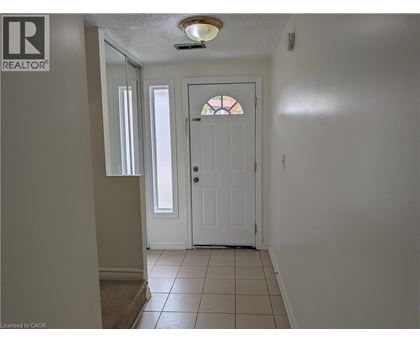 A hallway with a white door and a window.