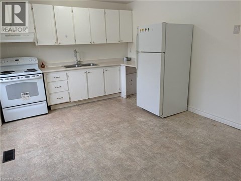 A kitchen with white appliances and cabinets.