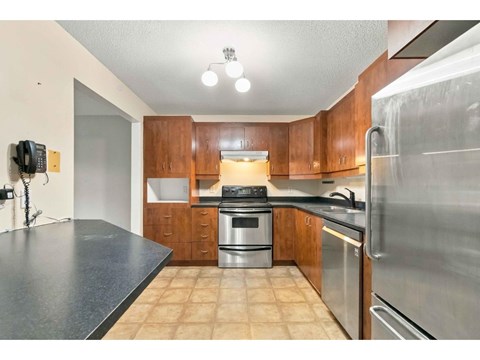 A kitchen with wooden cabinets and stainless steel appliances.