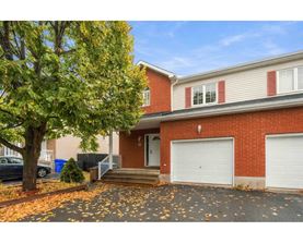 A house with a red brick exterior and a white garage door.