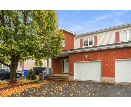 A house with a red brick exterior and a white garage door.