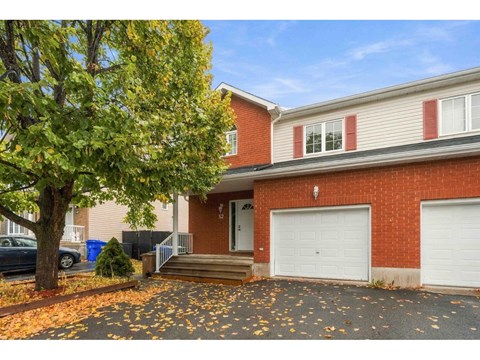 A house with a red brick exterior and a white garage door.