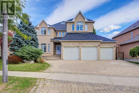 A large house with a driveway in front of it.