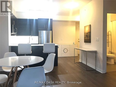 A modern kitchen with a dining table and chairs.