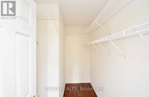 A white room with a wooden table and a white door.