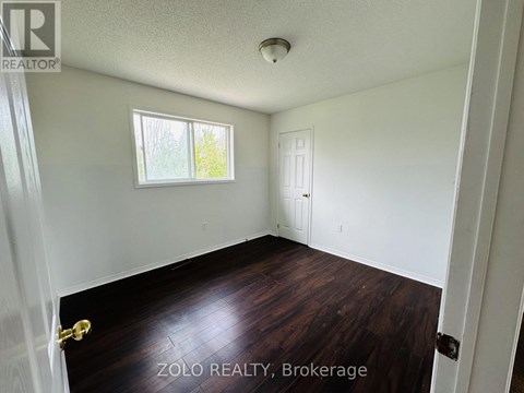 A room with a window and a door is for sale.