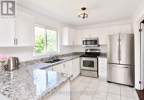 A kitchen with granite countertops and stainless steel appliances.