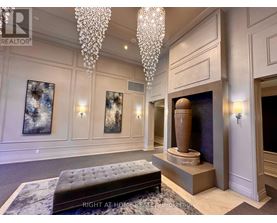 A living room with a chandelier, a fireplace, and a bench.