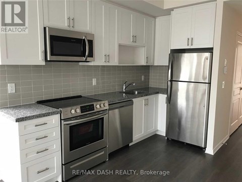 A kitchen with a stainless steel refrigerator, oven, and microwave.