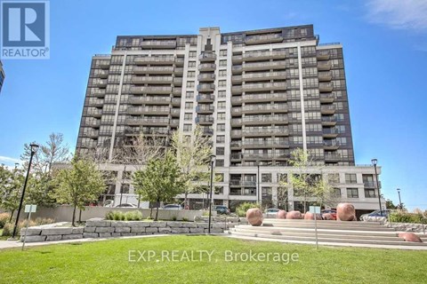 A tall residential building with a lawn in front.