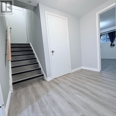 A room with a staircase leading to the upper floor.