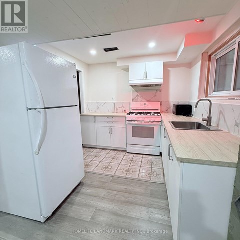 A white refrigerator stands in a kitchen with a wooden counter.
