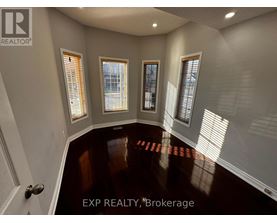A room with EXP REALTY, Brokerage written on the floor.
