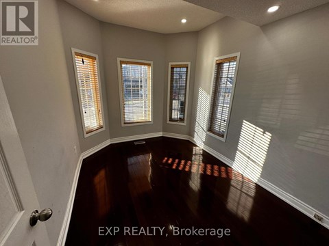 A room with EXP REALTY, Brokerage written on the floor.