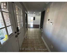 A hallway with a door on the left and a wall on the right.