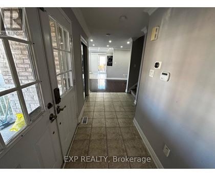 A hallway with a door on the left and a wall on the right.