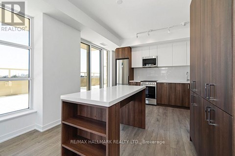 A modern kitchen with wooden cabinets and a central island.