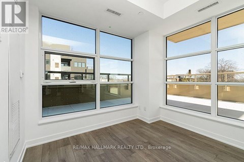 A room with a large window overlooking a building.