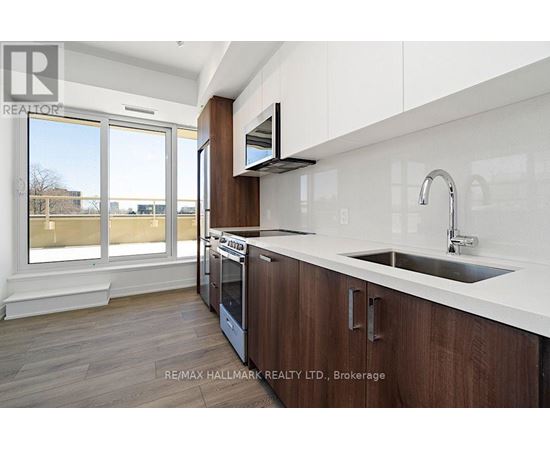 A modern kitchen with wooden cabinets and a white countertop.