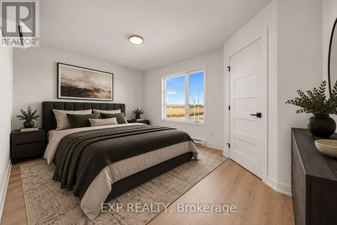 A bedroom with a large bed and a painting on the wall.