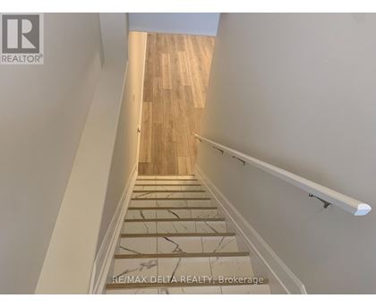 A staircase with wooden steps and a white handrail.