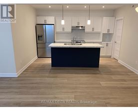A kitchen with a black countertop and white cabinets.