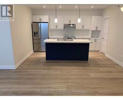 A kitchen with a black countertop and white cabinets.