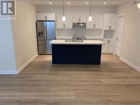 A kitchen with a black countertop and white cabinets.
