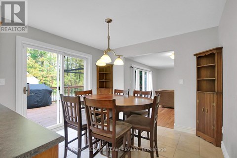 A dining room with a table and chairs.