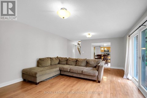 A living room with a couch and a lamp.