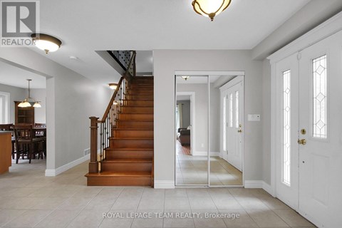 A spacious foyer with a staircase leading to the upper level.