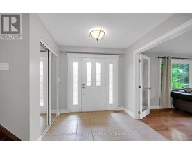 A white door with a glass panel is in the middle of a hallway.