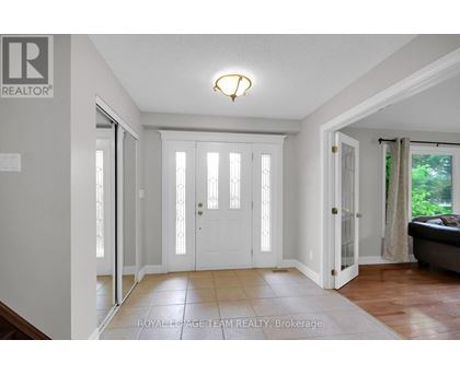 A white door with a glass panel is in the middle of a hallway.