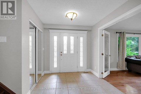 A white door with a glass panel is in the middle of a hallway.