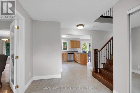 A spacious living room with a staircase leading to the upper floor.