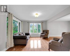 A living room with a couch, chair, and sliding glass doors.