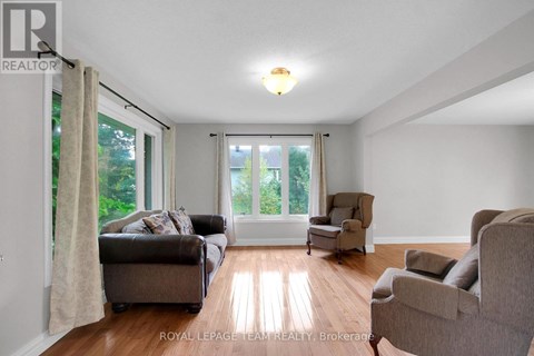 A living room with a couch, chair, and sliding glass doors.