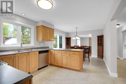 A kitchen with wooden cabinets and a black countertop.